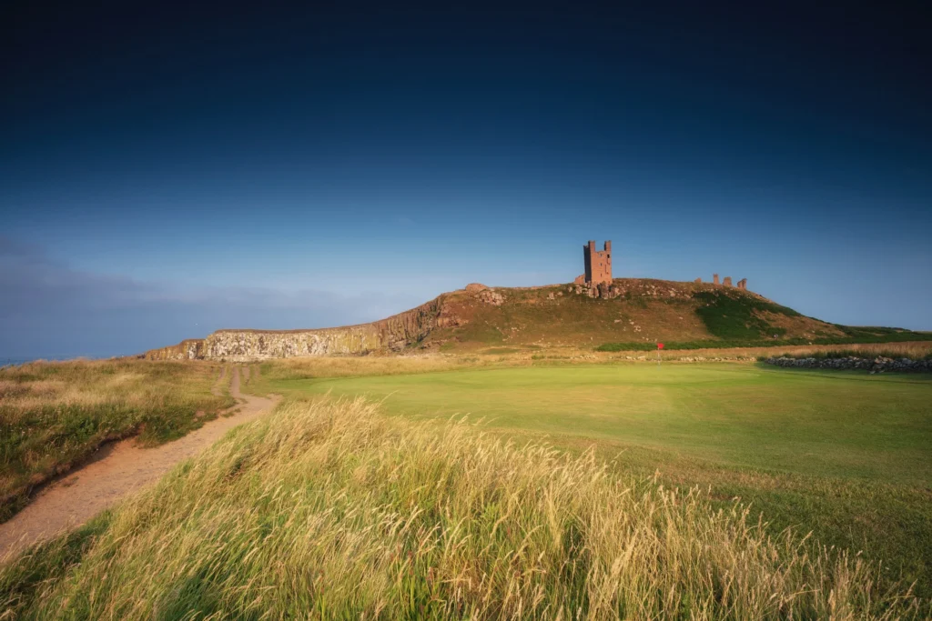 Dunstanburgh Castle Golf Club with the castle ruins