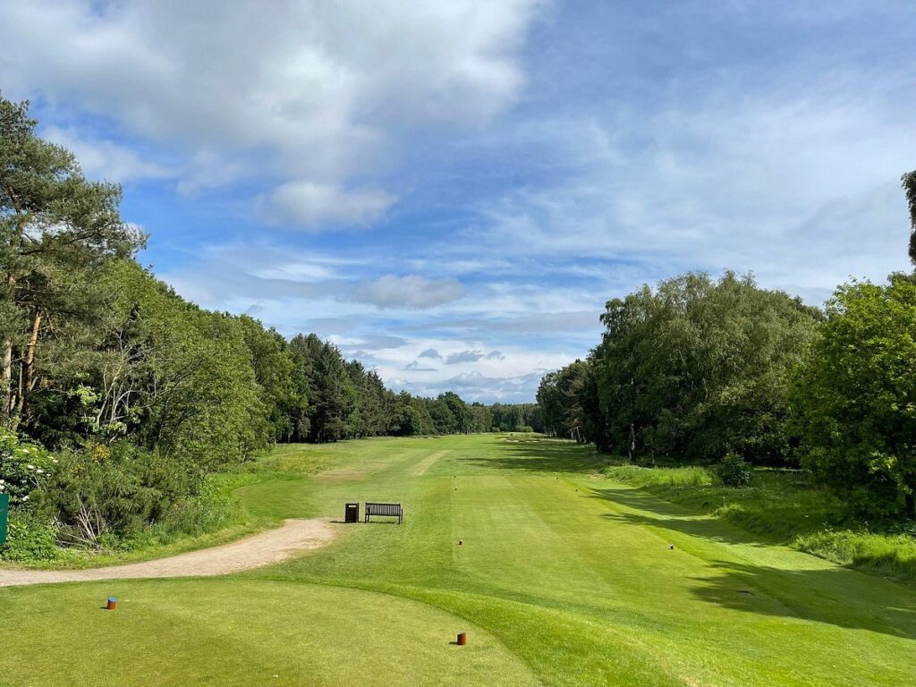 View from a tee down a tree-lined fairway at Fulford Golf Club in York