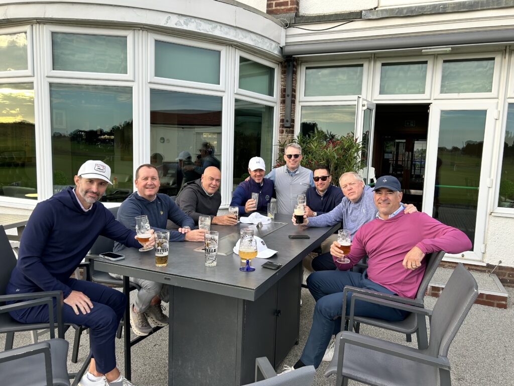 Epic Golf Travel group relaxing on a clubhouse terrace on England’s Golf Coast
