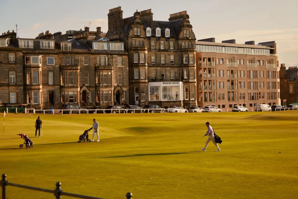 Golfers on the 18th fairway of the Old Course at St Andrews with Rusacks Hotel behind