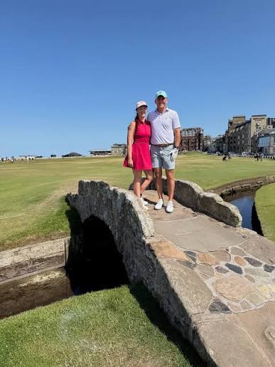Two golfers standing on the Swilcan Bridge on the Old Course, St Andrews