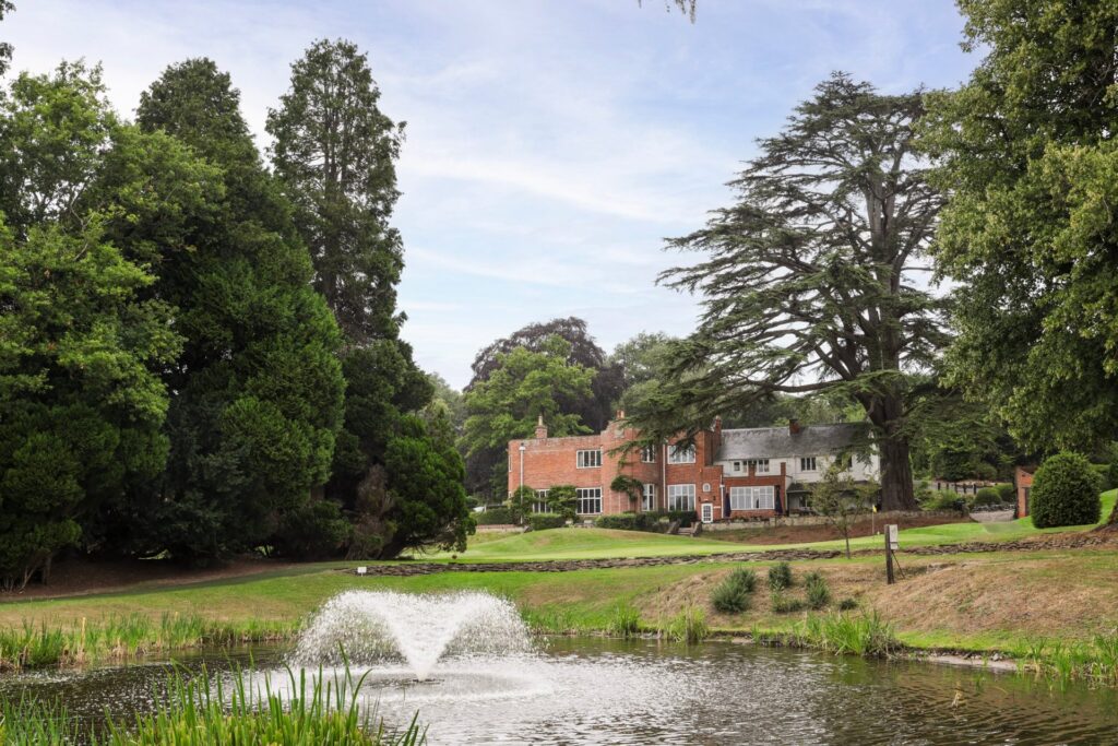The clubhouse at Donnington & Co seen across the lake